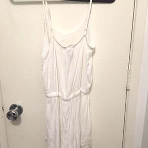 White romper, strings attach with metal clips.